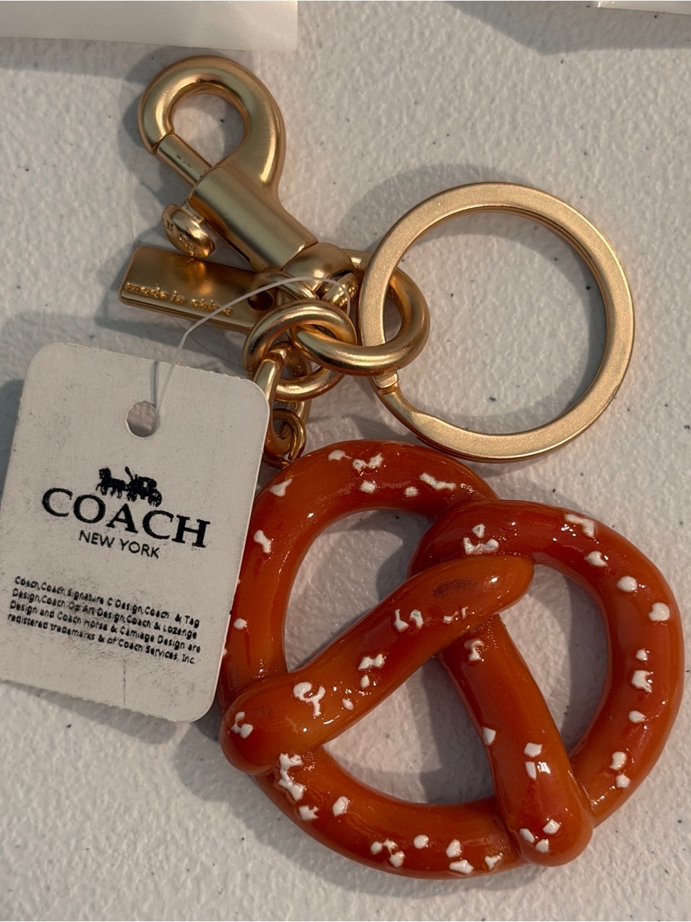 COACH Gold-Tone Key Ring with Orange Pretzel Charm